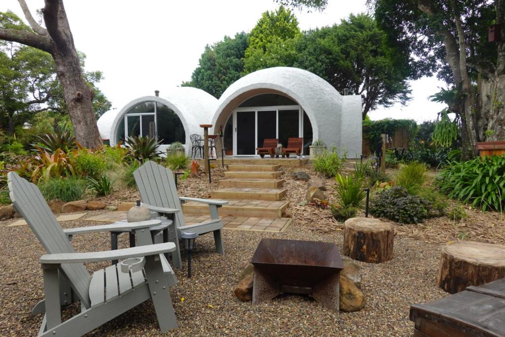 a white house with two chairs and a table at Sunshine Coast Hinterland Igloo Retreat Romantic & Private in Flaxton