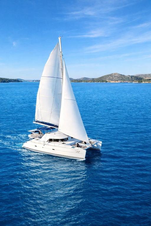 a white sail boat in the middle of the water at Nuit en Catamaran aux Iles de Lérins in Cannes