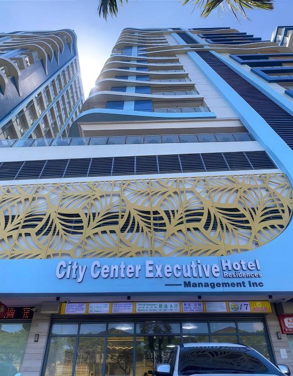 a tall building with a city center executive hotel at City Center Hotel Manila Near Airport and PITX Casinos Exhibition Center in Manila
