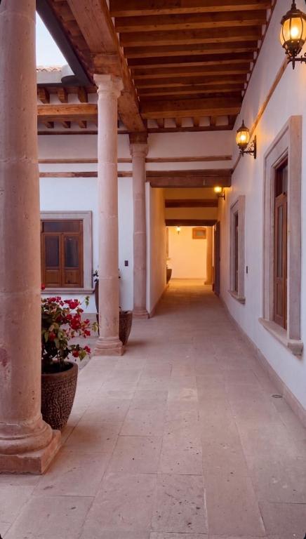 an empty hallway of a building with columns at Casa Cairo Pátzcuaro in Pátzcuaro