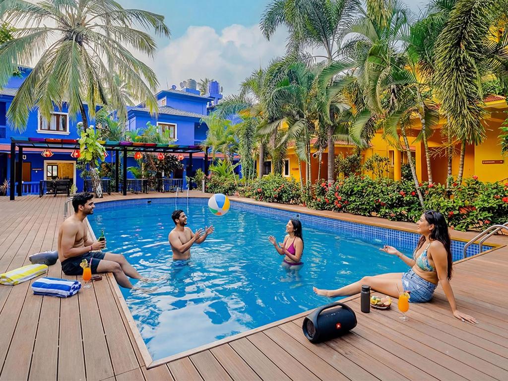 a group of people sitting in a swimming pool at The Hosteller Goa, Anjuna in Arpora
