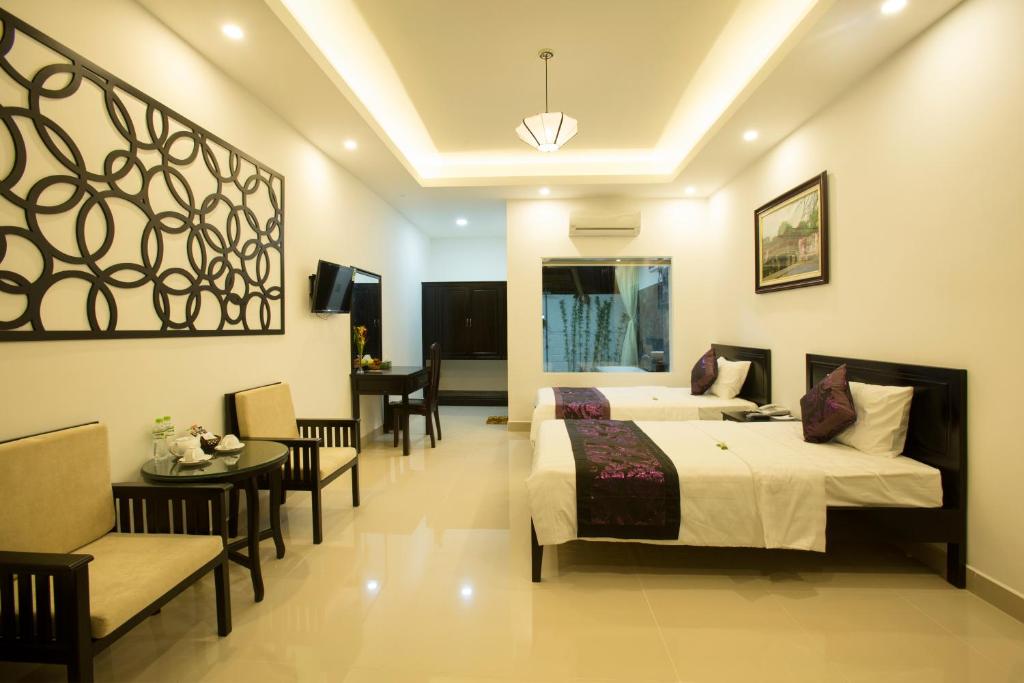 Cama o camas de una habitación en Hoi An Hideaway Villa