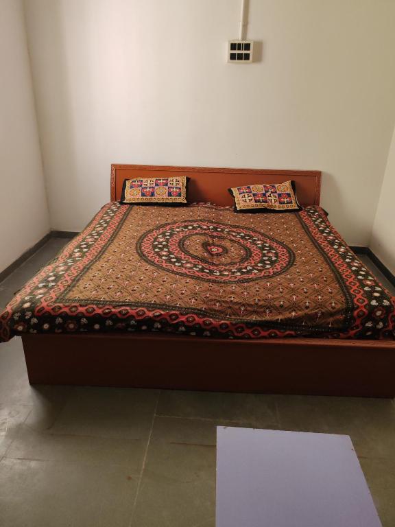 a bed with two pillows on it in a room at Cnc in Vadodara