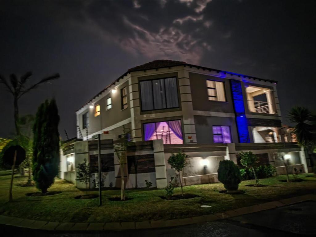 a building with blue lights on the side of it at XLA Home Guest house in eMalahleni
