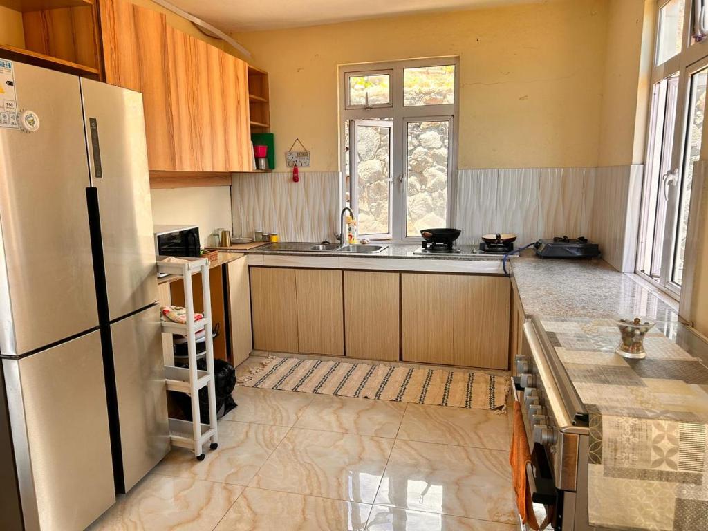 a kitchen with a refrigerator and a sink at EcoDream Lodge in Abercrombie