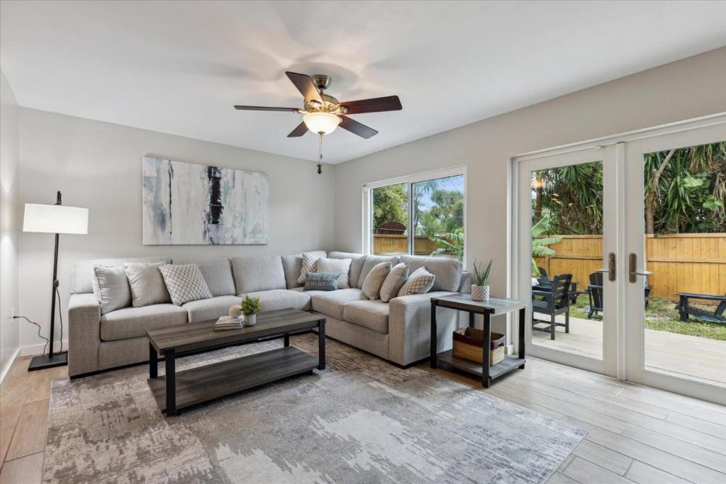 a living room with a couch and a ceiling fan at 10 Colonial Drive in Cocoa Beach