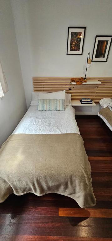 a bedroom with a large bed with a wooden headboard at URA Agua Apartamento 2 in Sopuerta