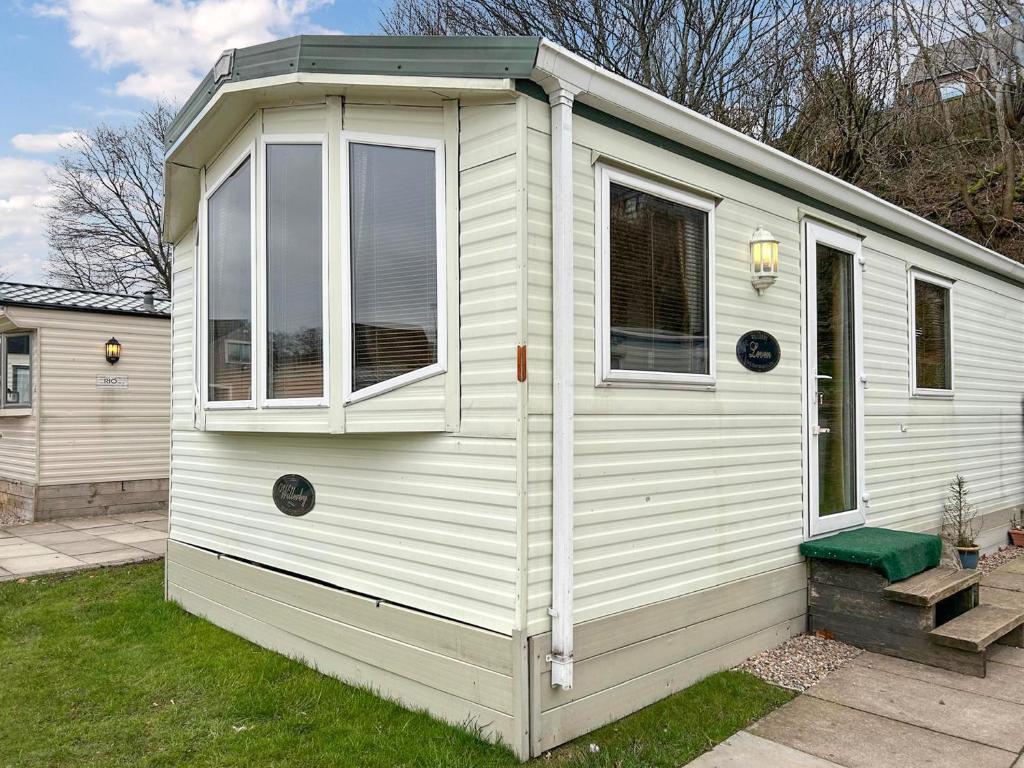 a white house with a window on the side of it at Uk51366 - The Harley Davidson in Brechin
