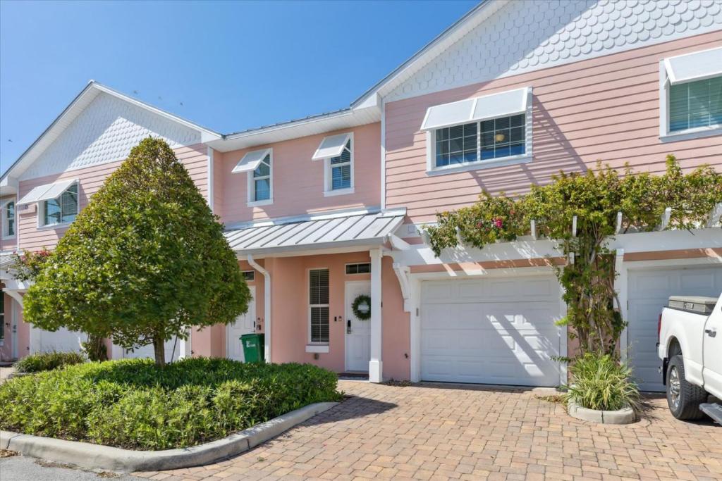 a pink house with a white van parked in front of it at Cape Crossing 103 in Merritt Island