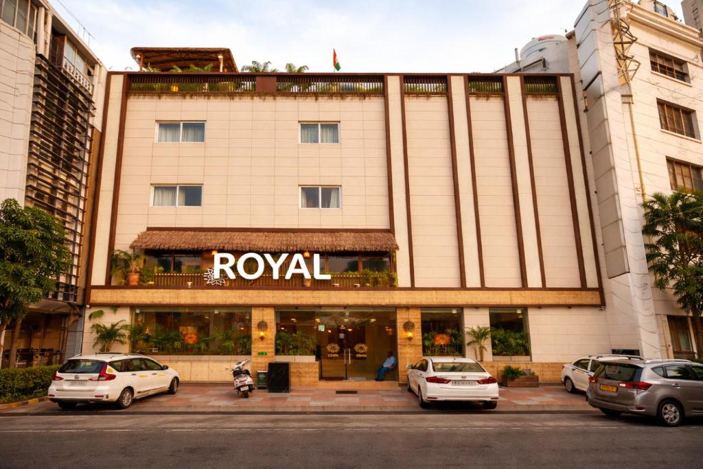 a hotel building with cars parked in front of it at OPO Premier Ro'yal Delhi Airport - FREE Airport Pickup Or Drop in New Delhi