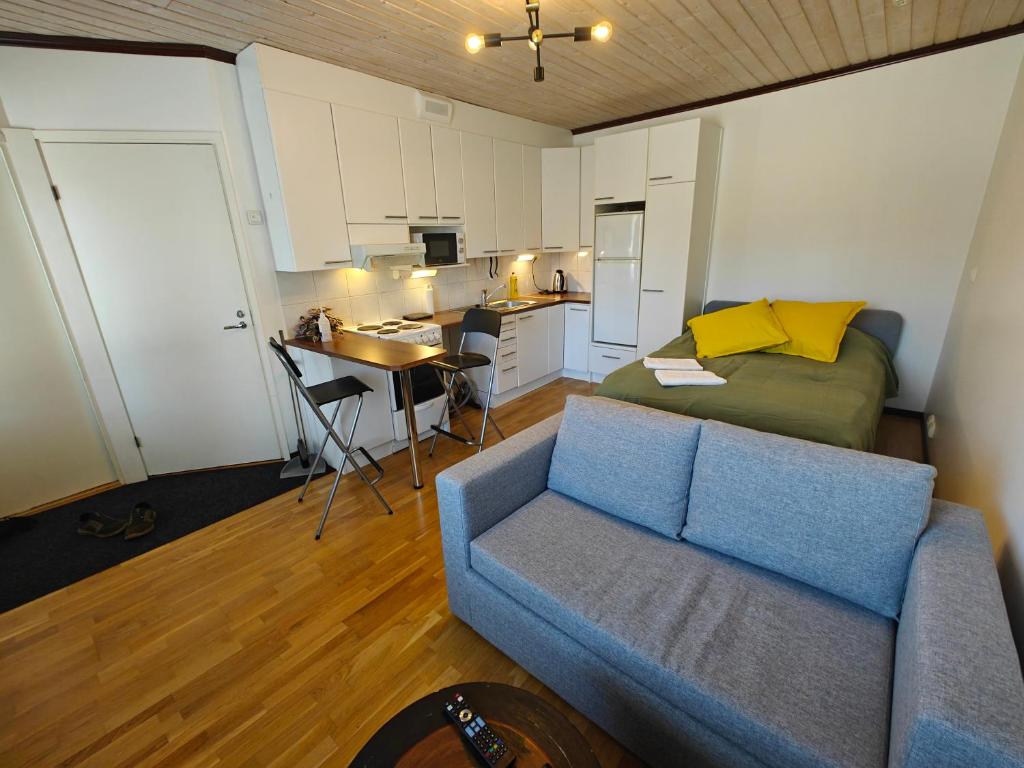 a living room with a couch and a kitchen at As 8 Viima inc Sauna in Valkeakoski