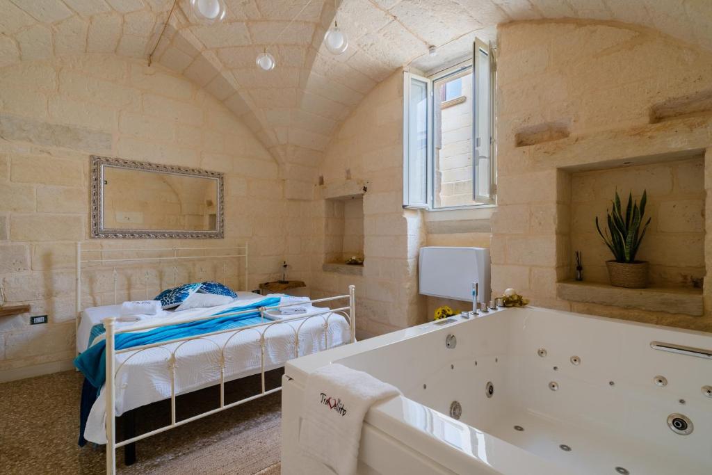a bedroom with a bed and a bath tub at Corte Cochlea La Curte Suite per 4 in Cannole