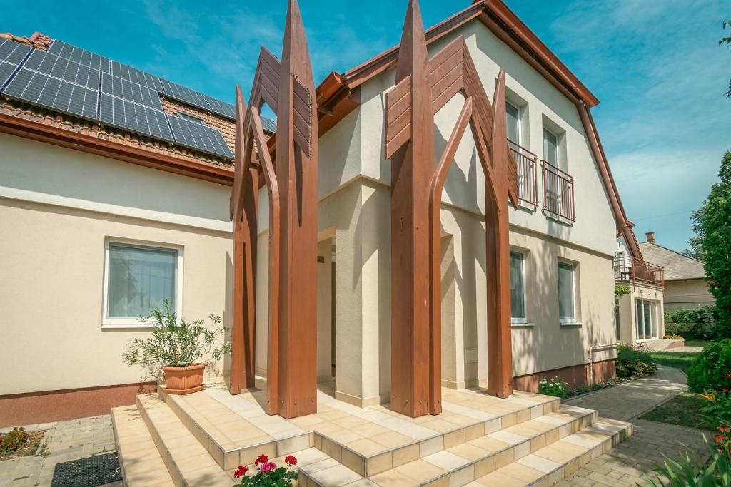 a house with solar panels on the roof at Rév-Panzió in Abádszalók