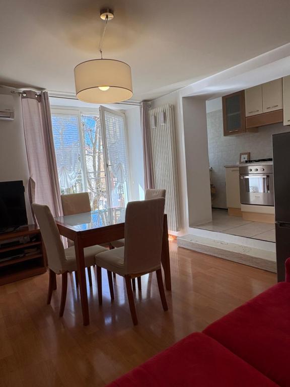 a living room with a dining room table and chairs at Casa Polly in Rovereto