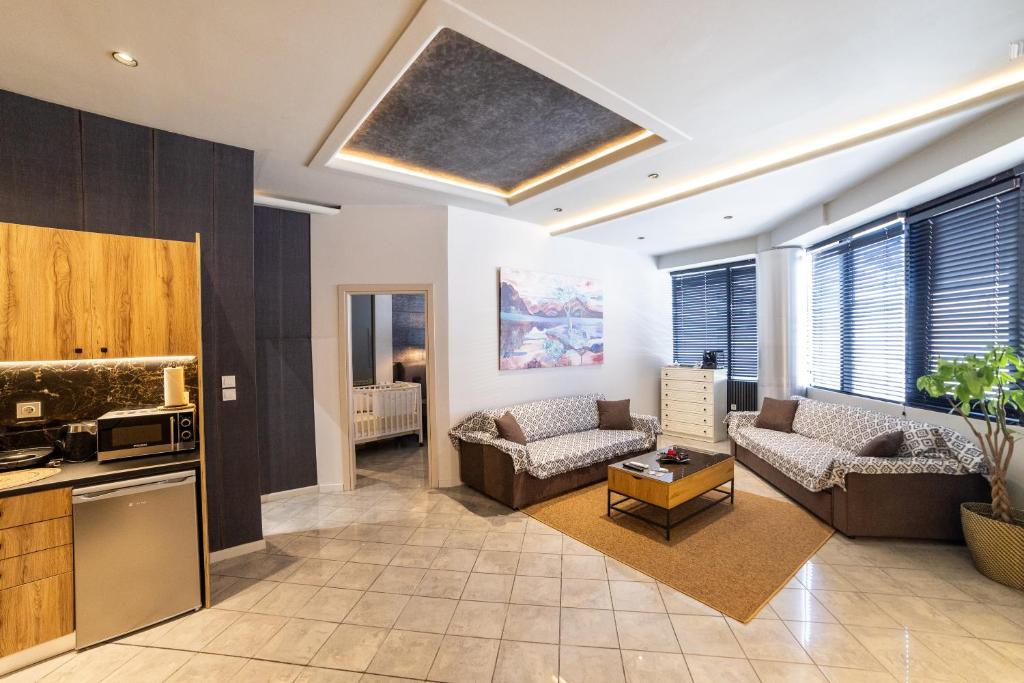 a living room with a couch and a table at Omega Suites 30 in Tríkala