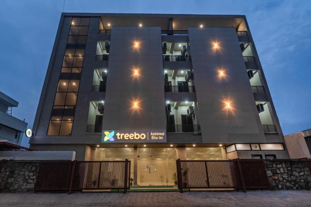 a building with a sign on the side of it at Treebo Aashirwad Bliss Inn With Swimming Pool in Jaipur