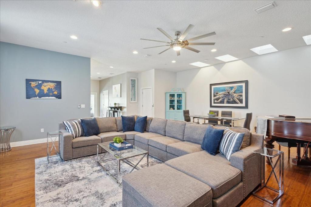 a living room with a couch and a piano at 51 N Orlando Ave in Cocoa Beach