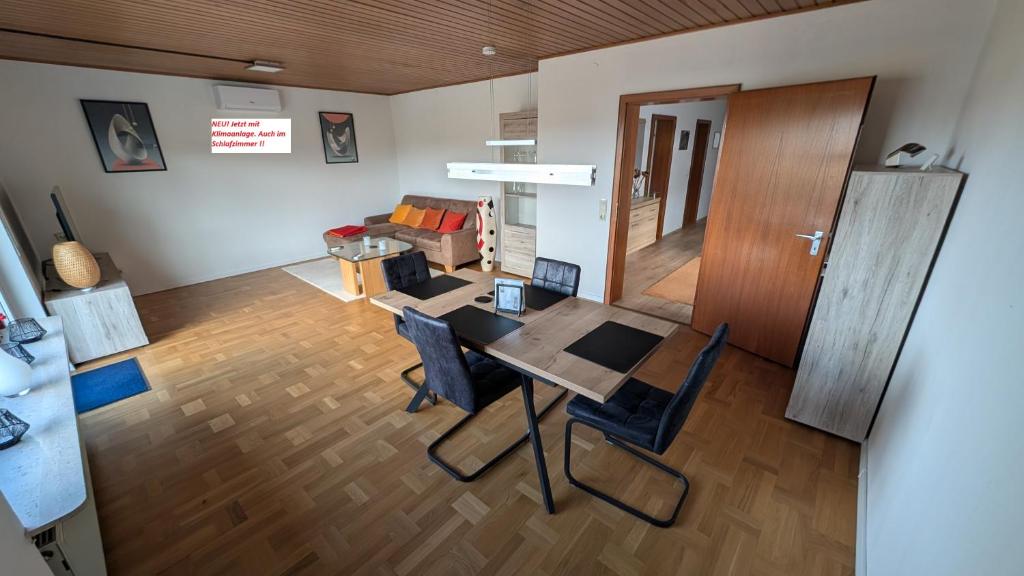 a dining room and living room with a table and chairs at Ferienhaus Kusel Blick in Kusel