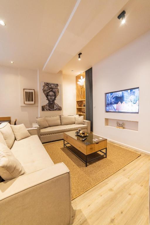 a living room with two couches and a coffee table at Omega Suites 31 in Tríkala