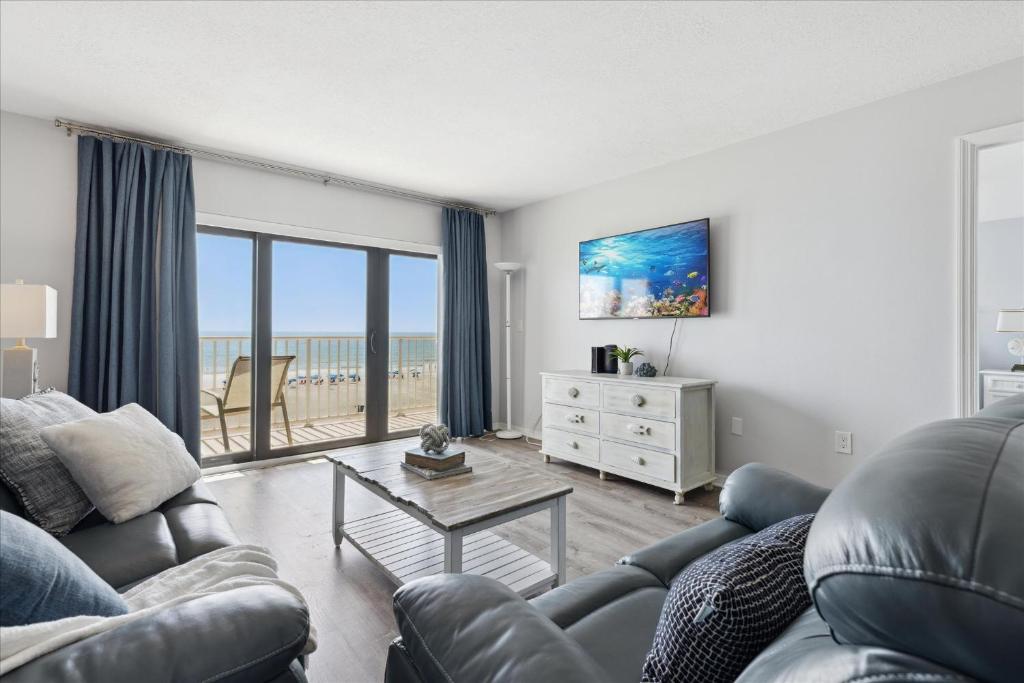 a living room with a couch and a table at Boardwalk 401 in Cocoa Beach