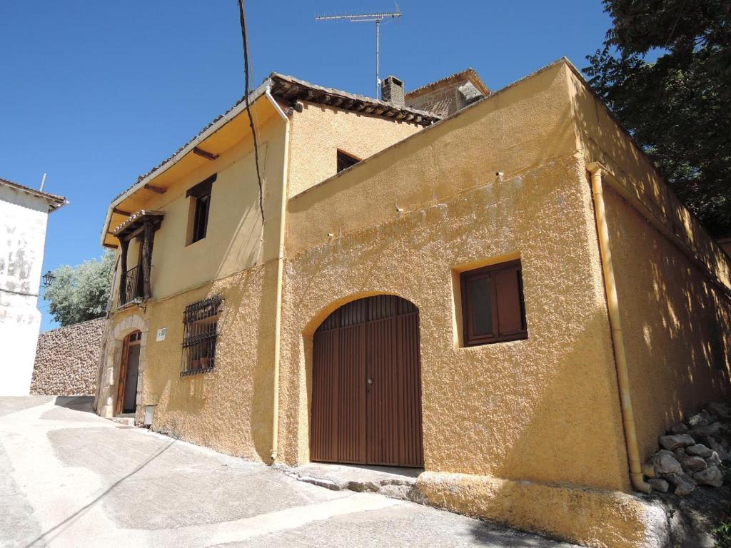 a building with a door on the side of it at Casa Rural Las Mieles in Chillarón del Rey