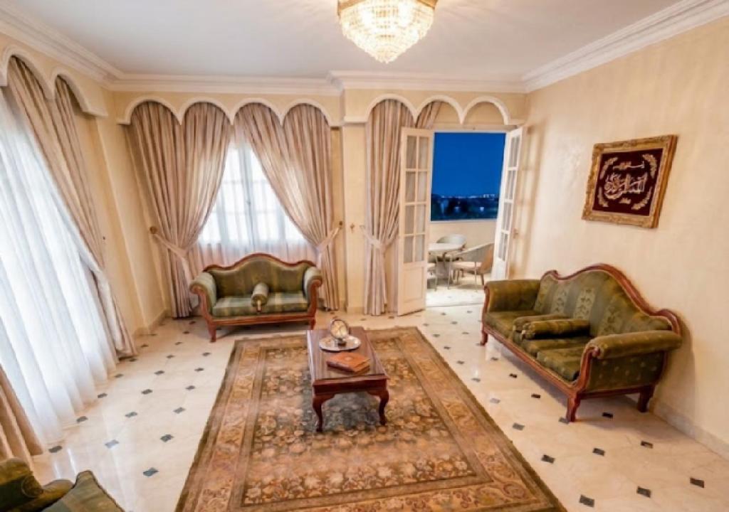 a living room with two couches and a table at HK Pyramids Guest House Hospitality& Kindness in Cairo