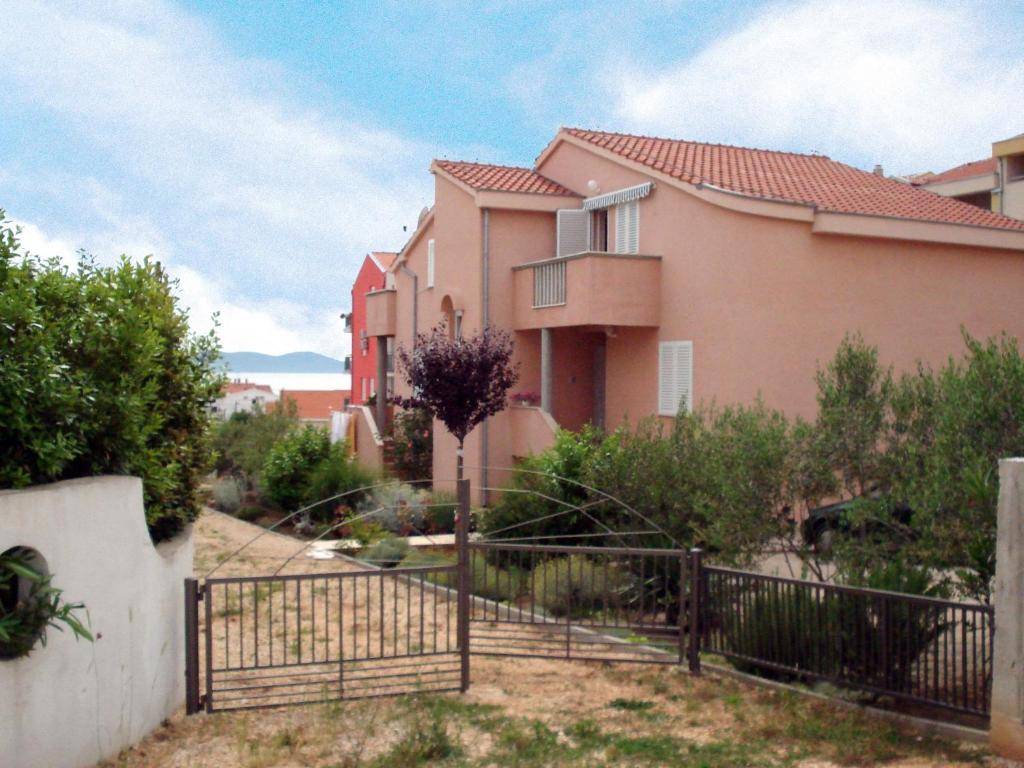 a house with a fence in front of it at Apartment in Zadar/Zadar Riviera 8067 in Smirić