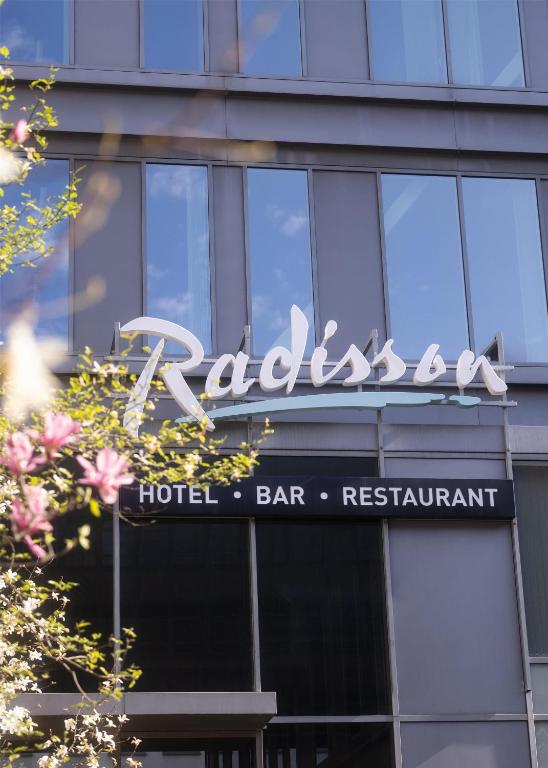 a hotel sign on the side of a building at Radisson Hotel Brussels Centre Midi in Brussels
