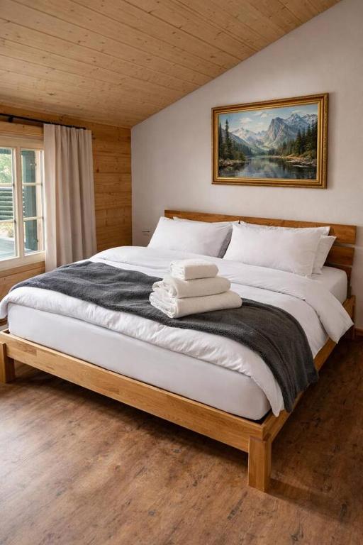 a bedroom with a large bed with white pillows at Ap1 20 min to Interlaken in Frutigen
