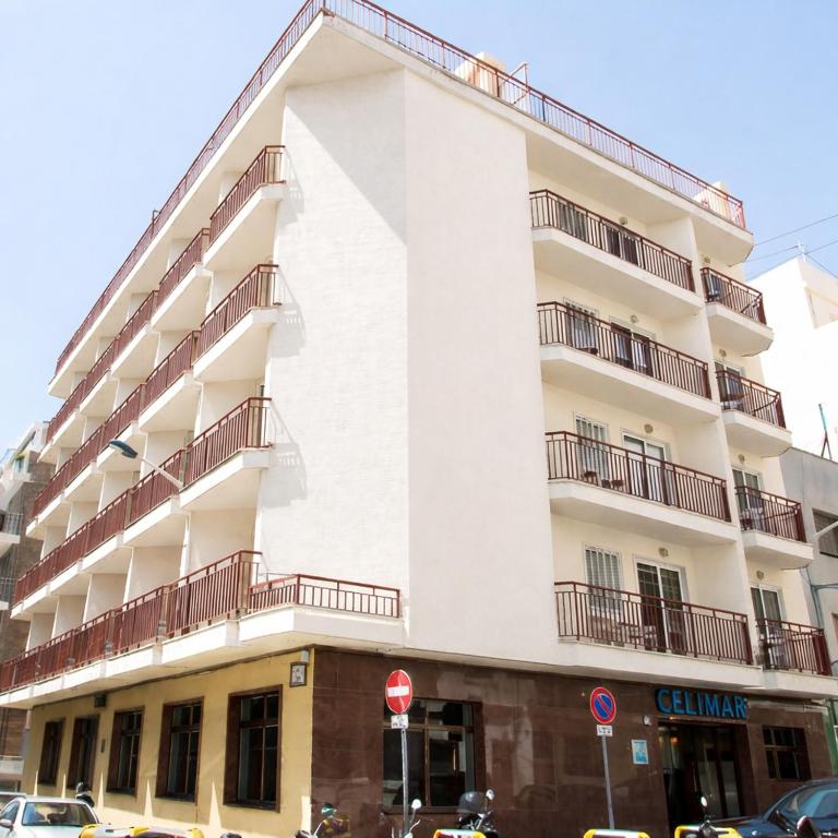 a white building with balconies on the side of it at Hotel Celymar in Benidorm