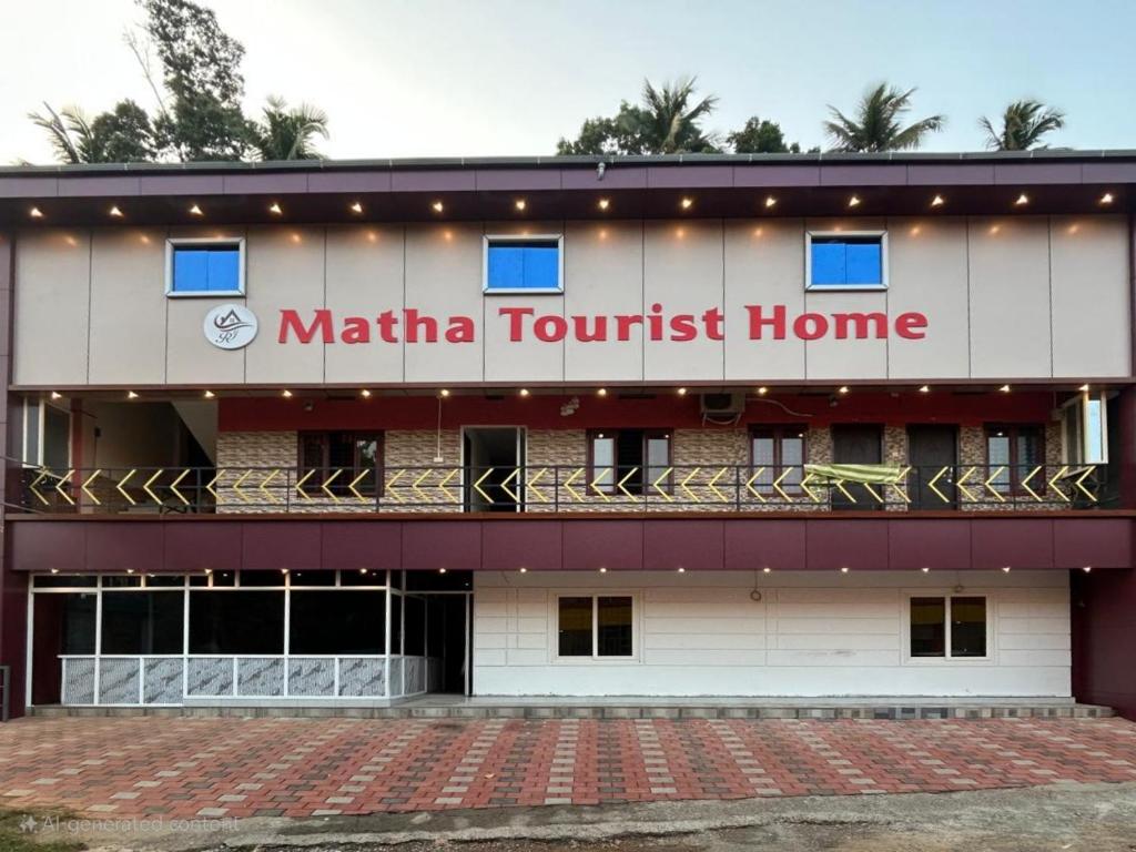 a building with a sign that reads matia tourist home at Matha Tourist Home , Cherupuzha in Peringom