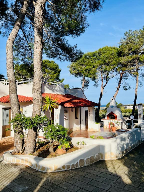 a house with trees in front of it at Villa Calipso in Taranto