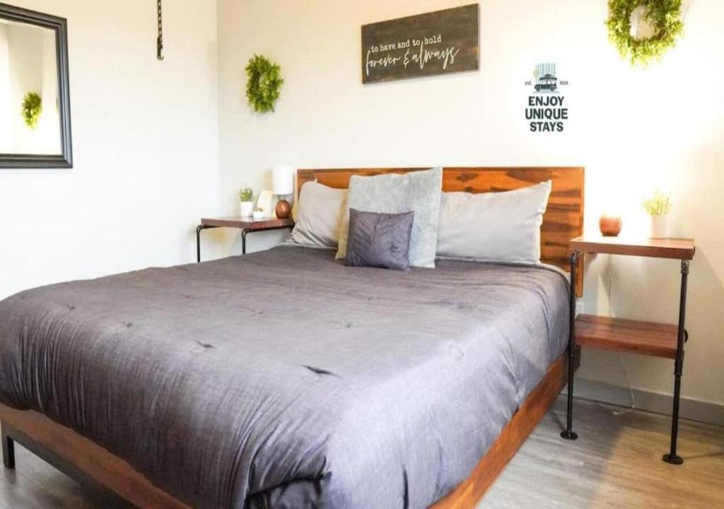 a bedroom with a large bed with a wooden headboard at Rivers Edge Lofts - Unit 7 in Niles