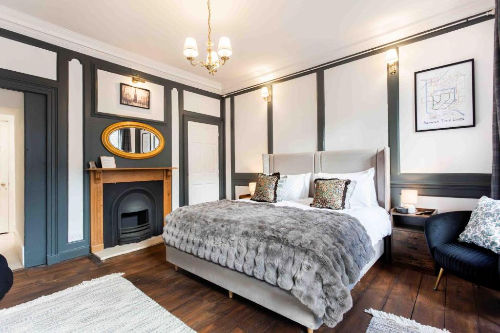 a bedroom with a bed and a fireplace at The Library at The Merchants in Fenwick