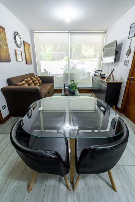 a living room with a couch and a glass table at Departamento full equipado Pucón - Casa Ayun in Pucón