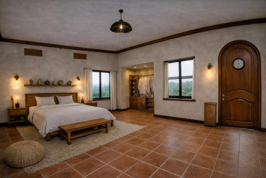 a large bedroom with a bed and a table at Your Sanctuary in Kasese