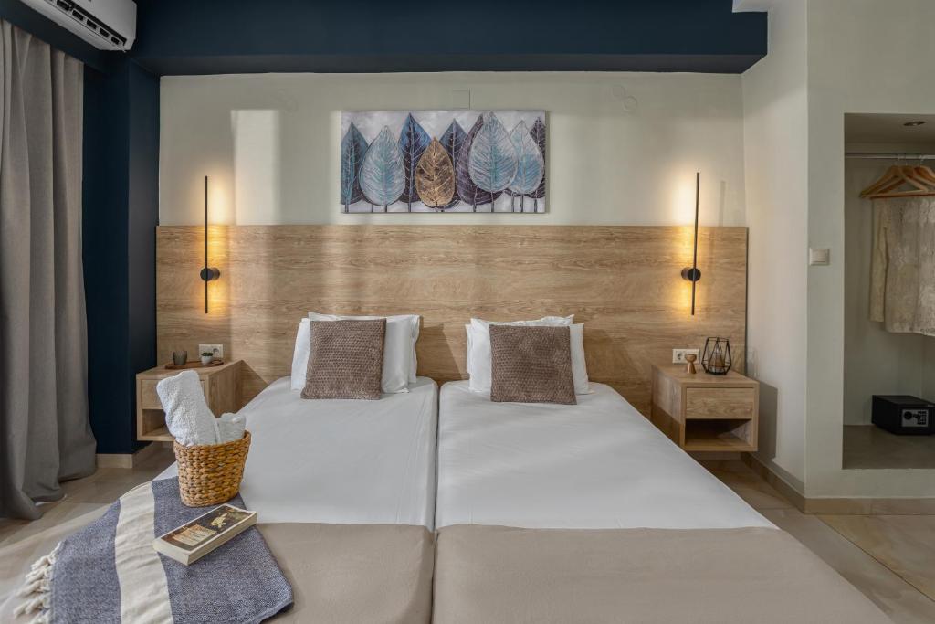 a bedroom with two white beds and two lamps at Argo Cozy Studios by Estia in Malia