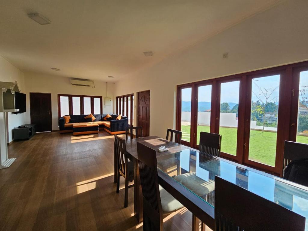 a living room with a table and a couch at Alpha bungalow in Kandy