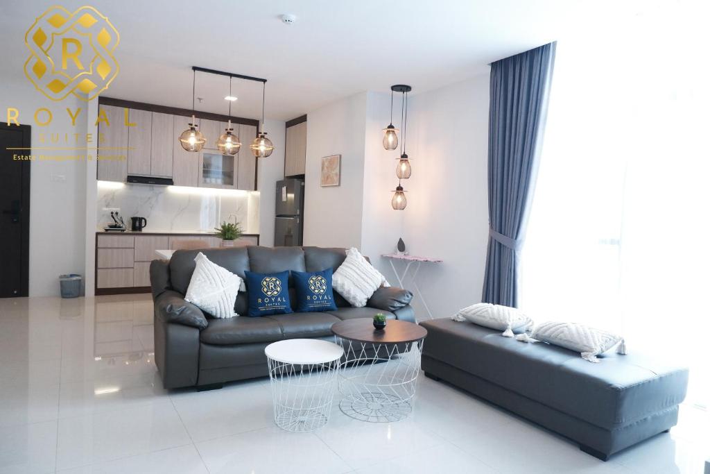 a living room with a couch and a table at Royal Suites 2BR - Formosa Residence in Jodoh