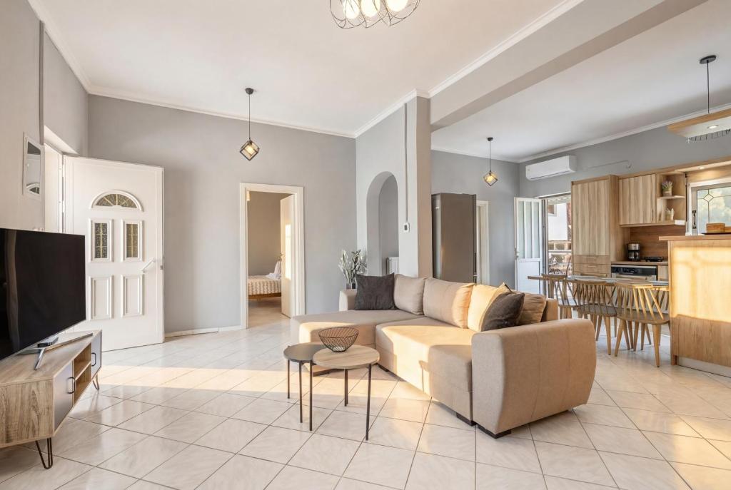 a living room with a couch and a kitchen at Martas Dream - Near Beach 2 Bedroom Deluxe Apartment in Daratso
