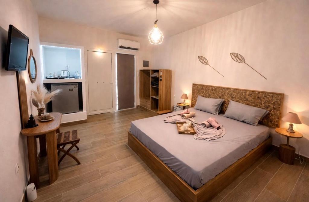 a bedroom with a bed with a baby on it at Seaview Apartments in Anavyssos