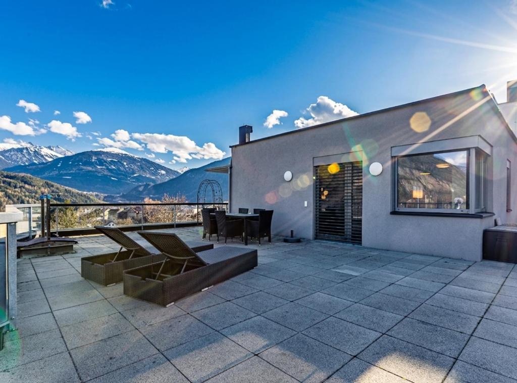 a house with a patio with mountains in the background at Penthouse in den Bergen im Tiroler Oberland in Imst