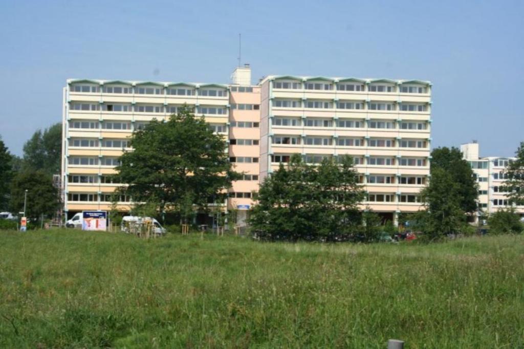 a large building in front of a field of grass at Fereinwohnung an der Ostsee E310 in Brasilien