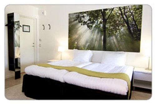 Postel nebo postele na pokoji v ubytování Hotell Tinget