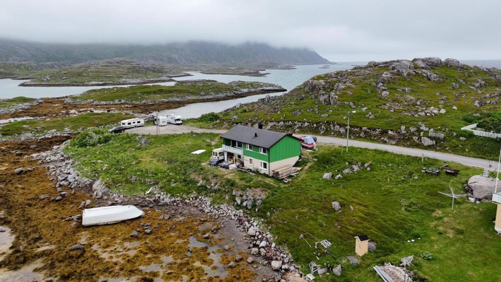 an island with a green house on top of it at Gjesvaer Fishing in Gjesvær