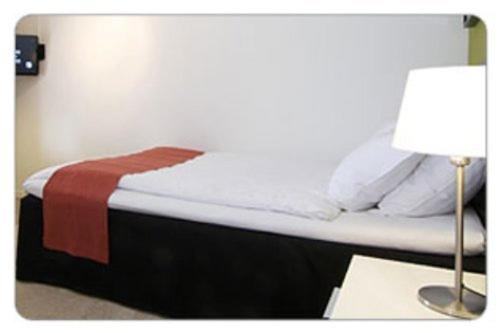Postel nebo postele na pokoji v ubytování Hotell Tinget