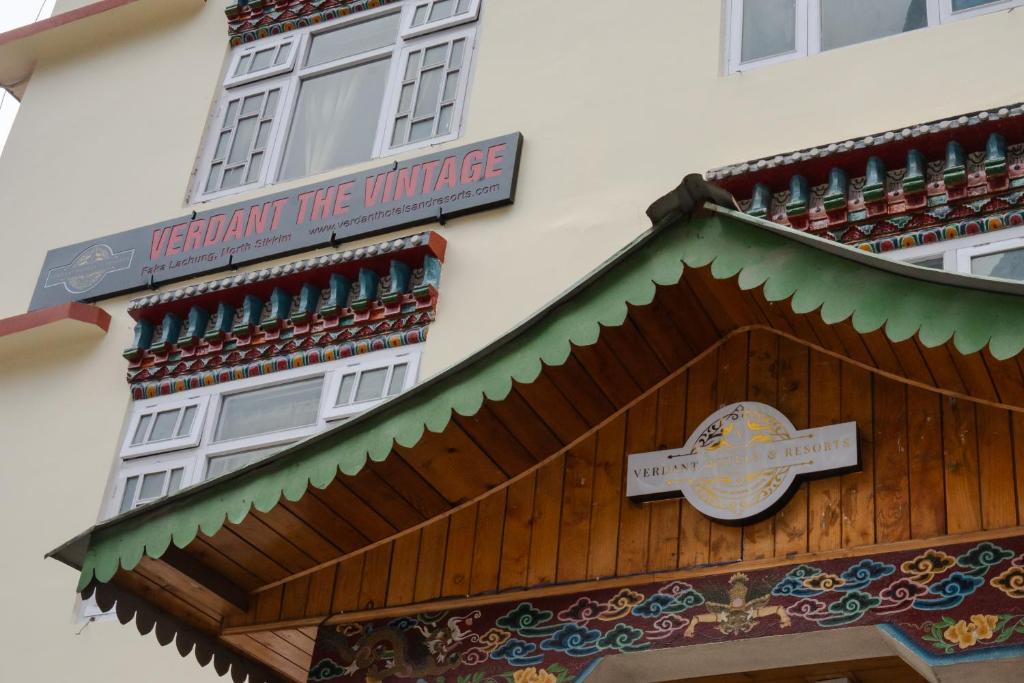 a sign on the side of a building with a cross at Verdant The Vintage in Lachung