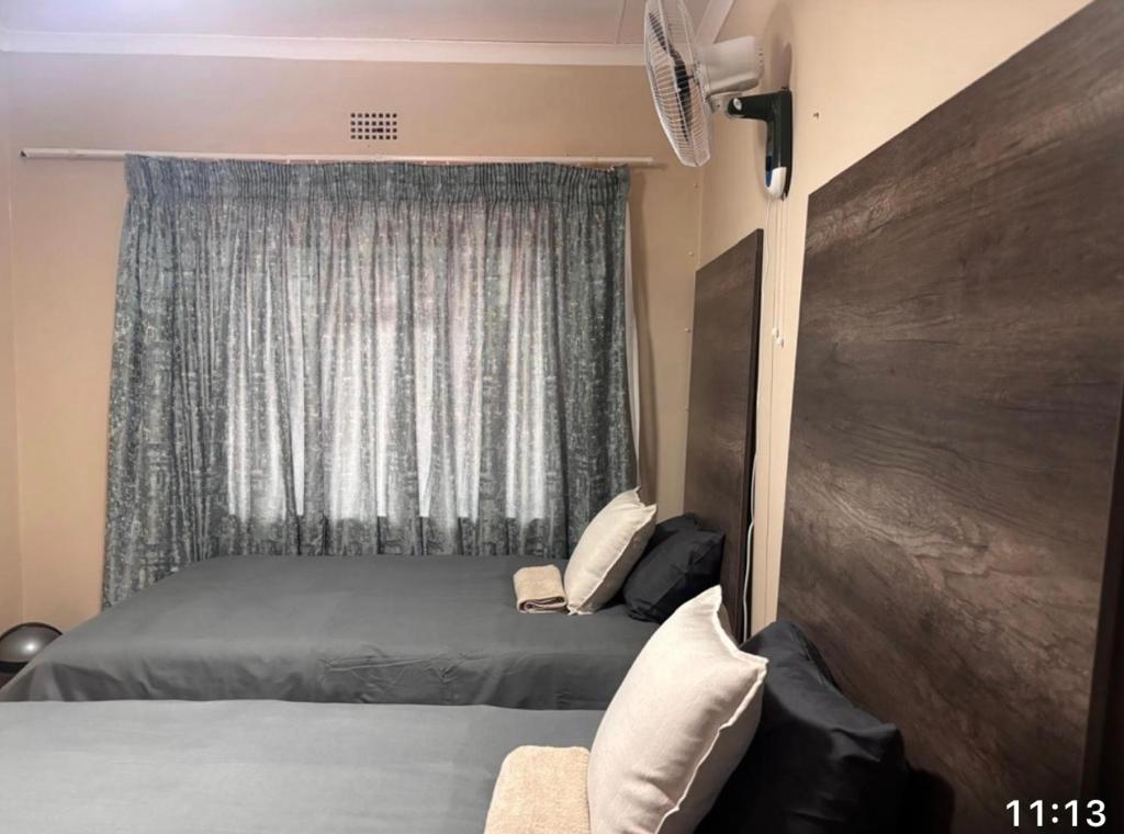 a bedroom with a bed and a window at Amatis House in Mokopane