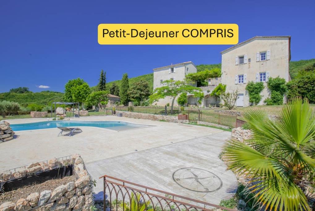 a villa with a swimming pool and a building at Chambre d'hôtes, Mas de Louise in Rousson