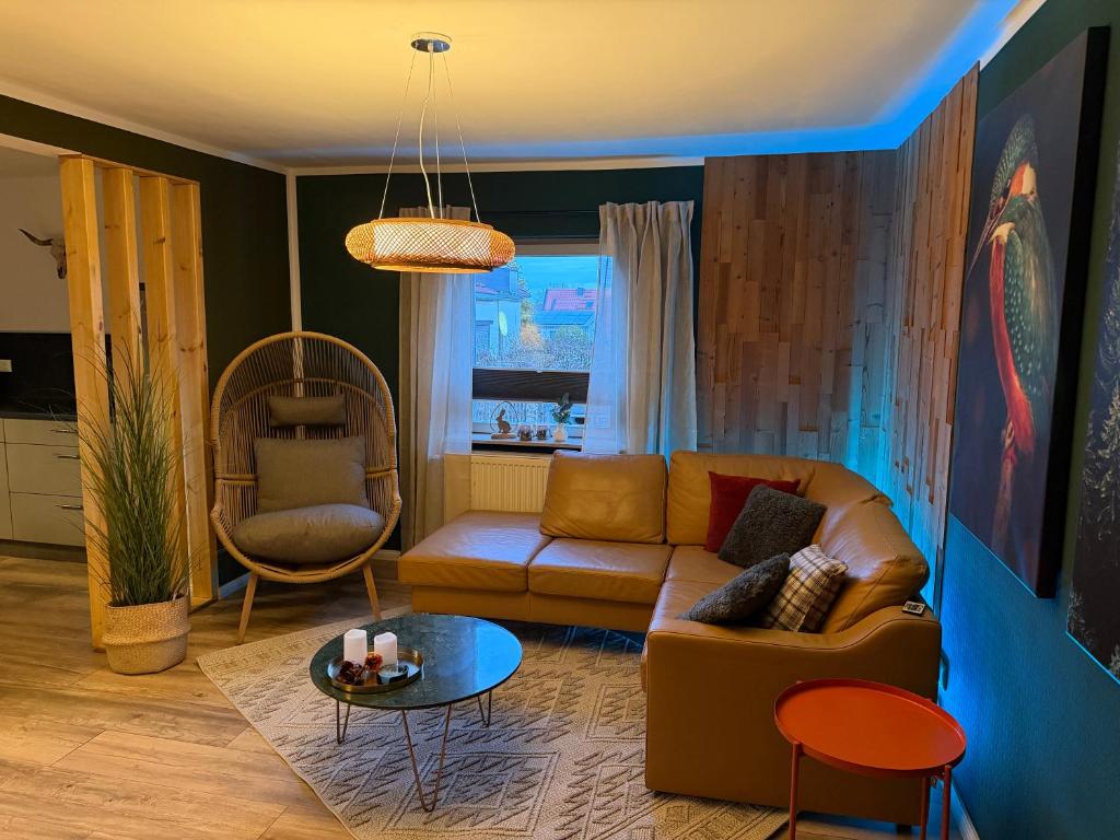 a living room with a couch and a table at Harzhaus Ida in Elbingerode
